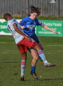 Issy Dean battles for the ball - Photography by Ray Spencer